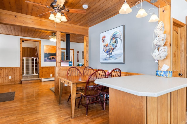412 Mill St, Sheridan, MT 59749 - dining room with wood ceiling, a baseboard radiator, a ceiling fan, a wainscoted wall, and light wood-type flooring