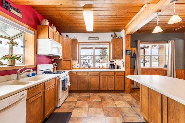 412 Mill St, Sheridan, MT 59749 - kitchen featuring white appliances, a sink, brown cabinetry, light countertops, and wood ceiling