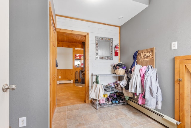 412 Mill St, Sheridan, MT 59749 - hallway with a baseboard heating unit, wood walls, and baseboard heating