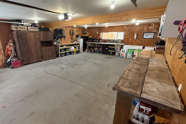 412 Mill St, Sheridan, MT 59749 - garage with a workshop area, a garage door opener, and wooden walls
