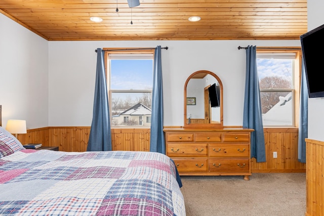 412 Mill St, Sheridan, MT 59749 - carpeted bedroom with wainscoting, wood ceiling, multiple windows, wooden walls, and recessed lighting