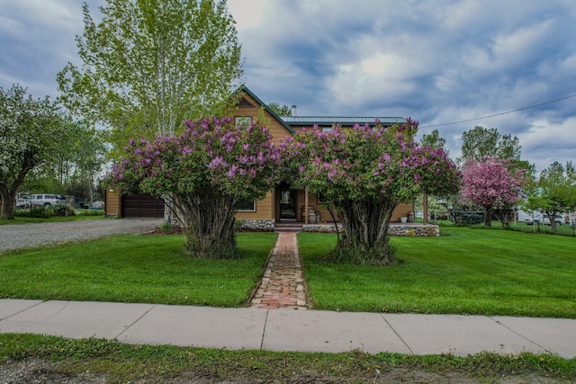 412 Mill St, Sheridan, MT 59749 - view of property hidden behind natural elements featuring driveway, a garage, and a front lawn
