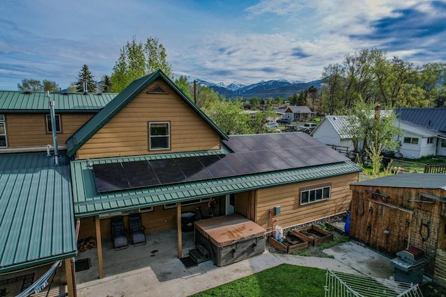 412 Mill St, Sheridan, MT 59749 - rear view of house with metal roof, a mountain view, a patio area, a standing seam roof, and an outdoor structure