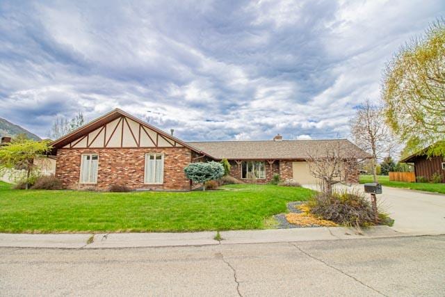 6 Cedar Lake Dr, Butte, MT 59701 - view of front of property featuring concrete driveway, a front lawn, and an attached garage