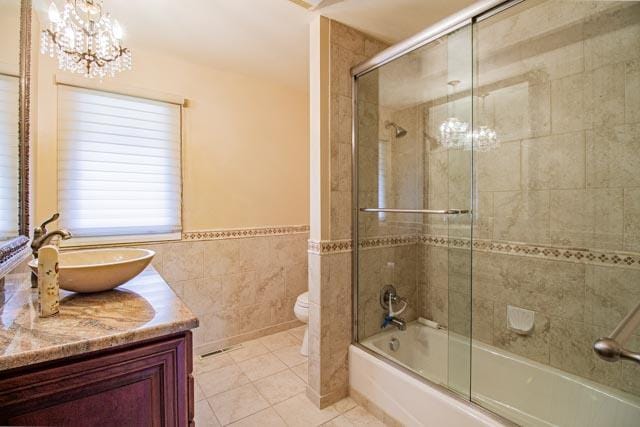 6 Cedar Lake Dr, Butte, MT 59701 - full bathroom with tile patterned flooring, toilet, vanity, tile walls, and a chandelier