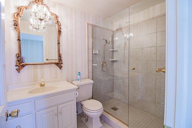 6 Cedar Lake Dr, Butte, MT 59701 - bathroom with a chandelier, wallpapered walls, a stall shower, toilet, and vanity