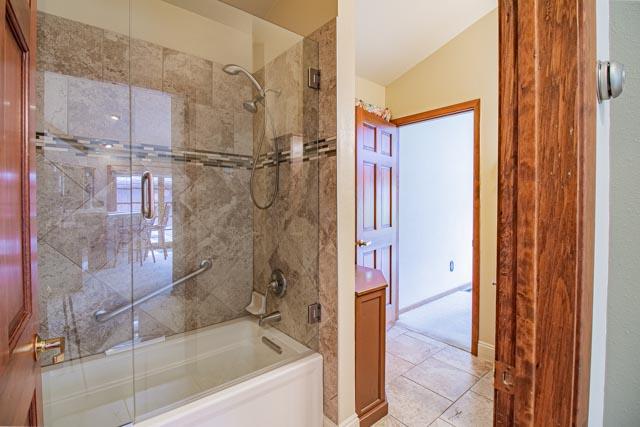 6 Cedar Lake Dr, Butte, MT 59701 - bathroom featuring enclosed tub / shower combo and vaulted ceiling
