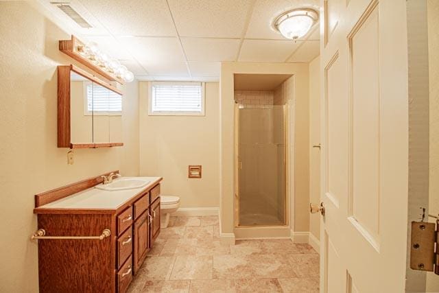6 Cedar Lake Dr, Butte, MT 59701 - full bath featuring a stall shower, baseboards, toilet, vanity, and a paneled ceiling