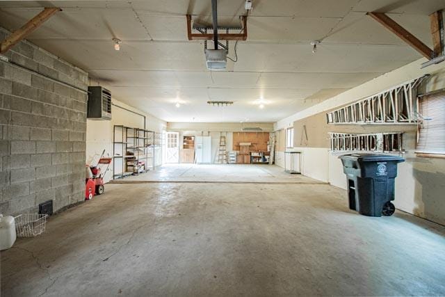 6 Cedar Lake Dr, Butte, MT 59701 - garage featuring a garage door opener and concrete block wall