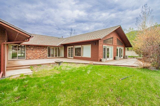 6 Cedar Lake Dr, Butte, MT 59701 - rear view of house with a wooden deck, a yard, roof with shingles, and french doors