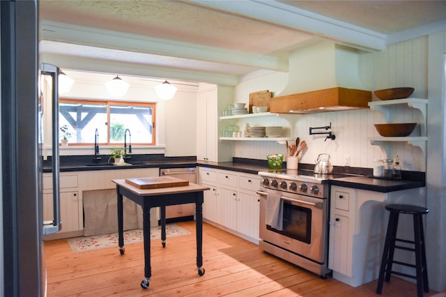 kitchen with stainless steel appliances, custom exhaust hood, open shelves, beam ceiling, and light wood-style floors