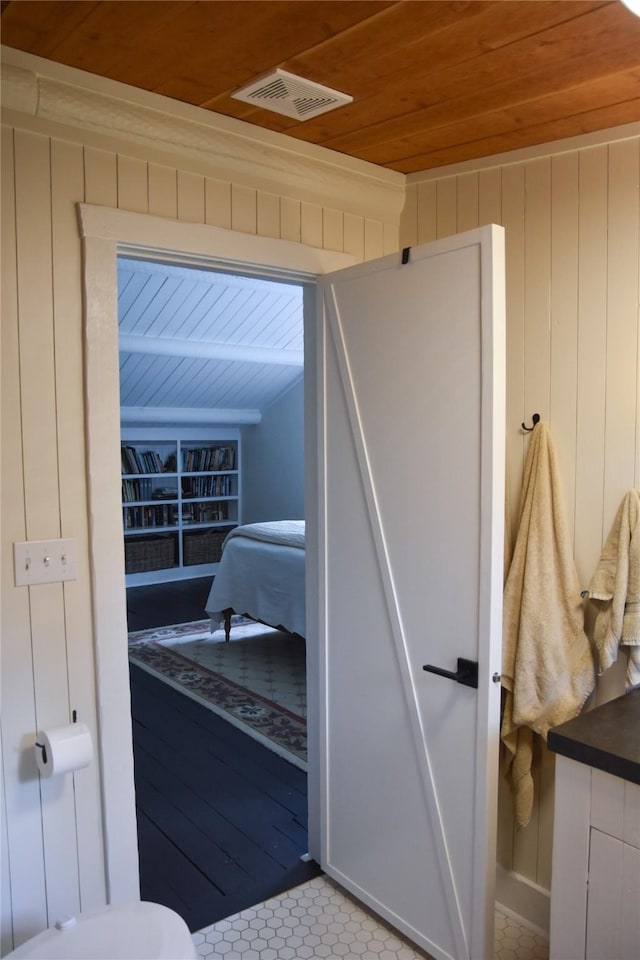 tiled bedroom featuring wood ceiling and wooden walls