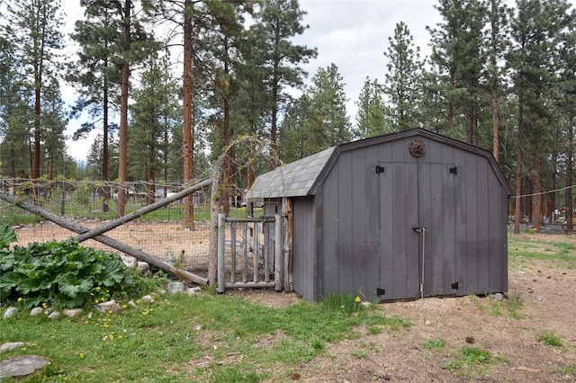 view of shed featuring fence