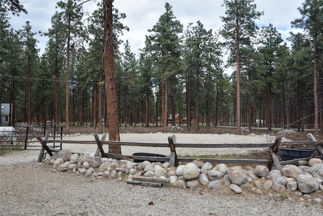 view of yard with a view of trees and fence