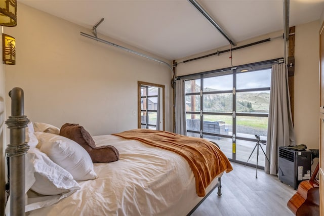 bedroom featuring access to outside and light wood-style flooring