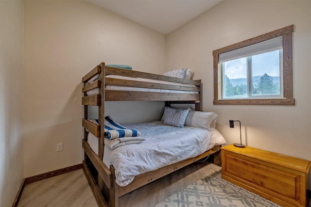 bedroom featuring light wood-style flooring and baseboards