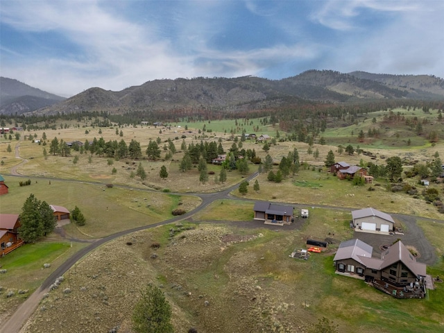 aerial view of property and surrounding area with a mountain backdrop and rural landscape