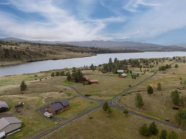 aerial view of property's location featuring a water and mountain view