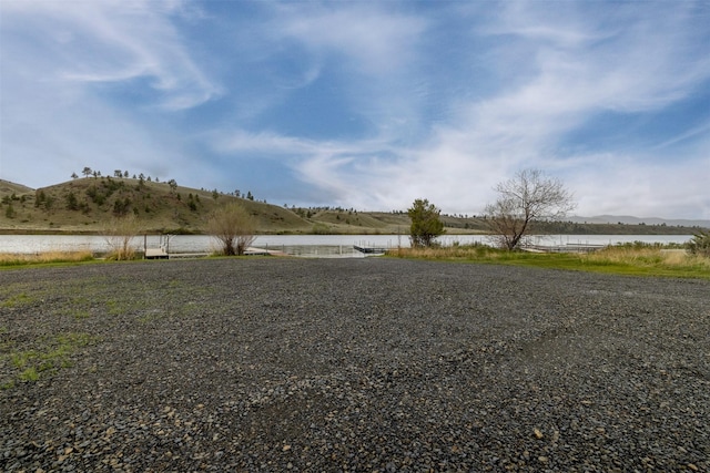 view of yard with a water and mountain view