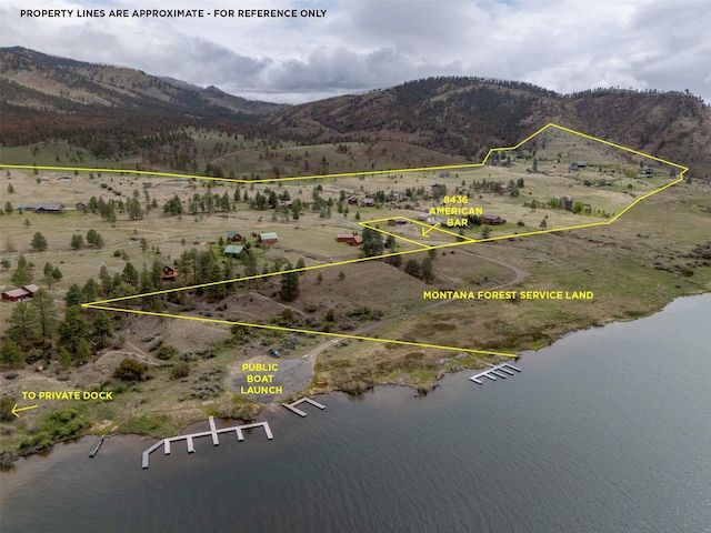 aerial view of property and surrounding area featuring a water and mountain view and property boundaries highlighted