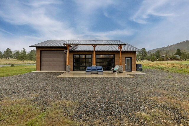 8436 American Bar Rd, Helena, MT 59602 - garage featuring a mountain view and driveway