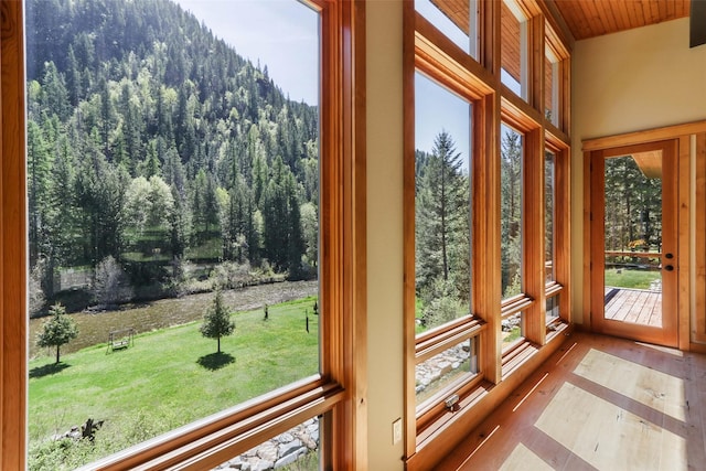 318 Mt Highway 56, Noxon, MT 59853 - unfurnished sunroom featuring a forest view, wood ceiling, and wood finished floors