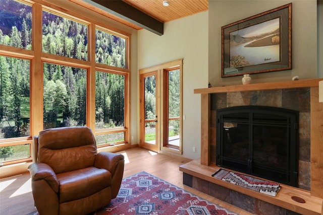 318 Mt Highway 56, Noxon, MT 59853 - living room with healthy amount of natural light, beamed ceiling, wood finished floors, wooden ceiling, and a fireplace