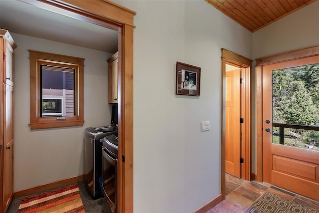 318 Mt Highway 56, Noxon, MT 59853 - laundry room with washer and dryer, cabinet space, baseboards, stone finish flooring, and wooden ceiling