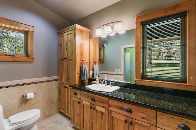 318 Mt Highway 56, Noxon, MT 59853 - bathroom with tile walls, tile patterned flooring, toilet, vanity, and wainscoting