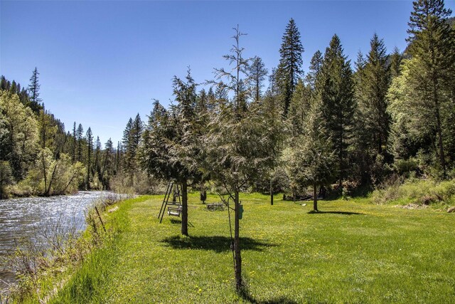 318 Mt Highway 56, Noxon, MT 59853 - view of community featuring a yard, a view of trees, and a water view
