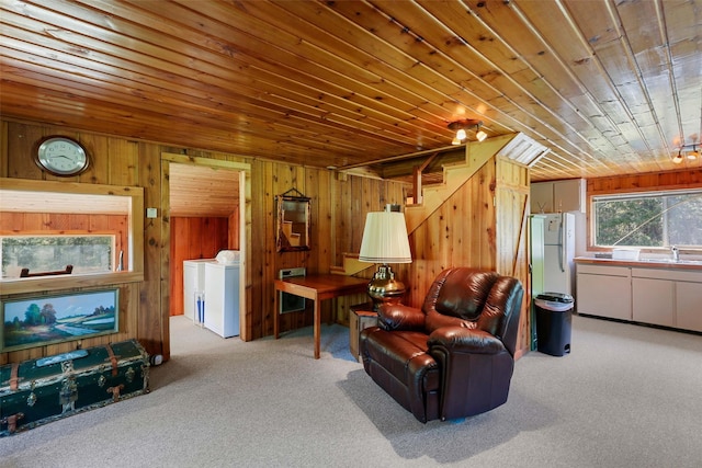 318 Mt Highway 56, Noxon, MT 59853 - living area with independent washer and dryer, carpet flooring, wooden ceiling, wooden walls, and stairway