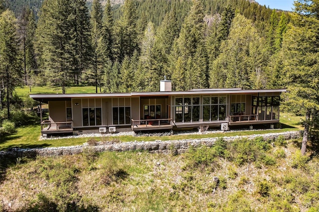 318 Mt Highway 56, Noxon, MT 59853 - rear view of property featuring a wooded view and a chimney