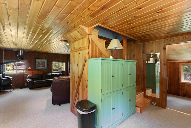 318 Mt Highway 56, Noxon, MT 59853 - living room featuring wooden ceiling, wood walls, carpet, and stairs