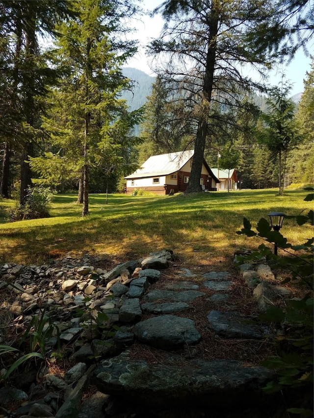 318 Mt Highway 56, Noxon, MT 59853 - view of green lawn with a mountain view and a view of trees