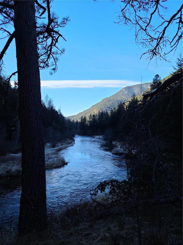 318 Mt Highway 56, Noxon, MT 59853 - water view with mountains and a heavily wooded area