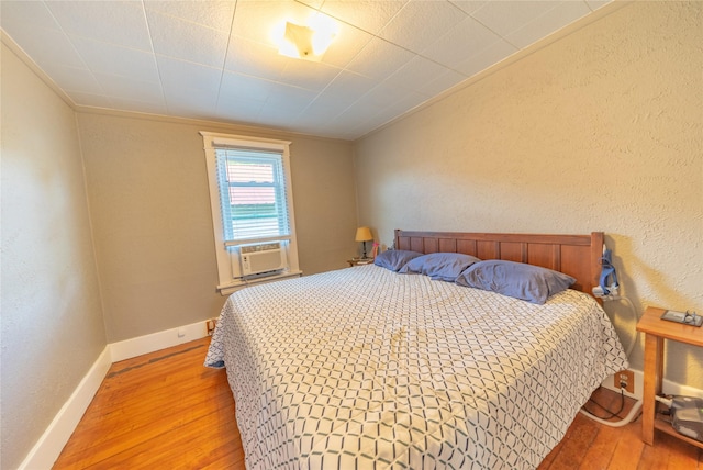 317 5th Ave W, Kalispell, MT 59901 - bedroom with hardwood / wood-style floors, ornamental molding, baseboards, a textured wall, and cooling unit