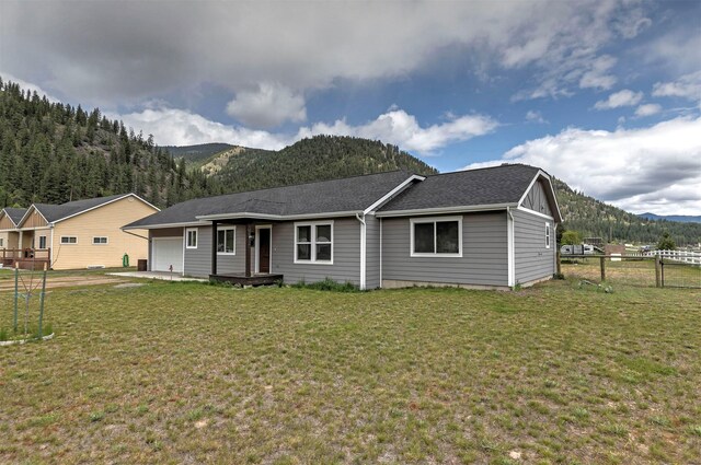 301 Bernie Rd, Alberton, MT 59820 - view of front of home featuring a mountain view, an attached garage, and a shingled roof