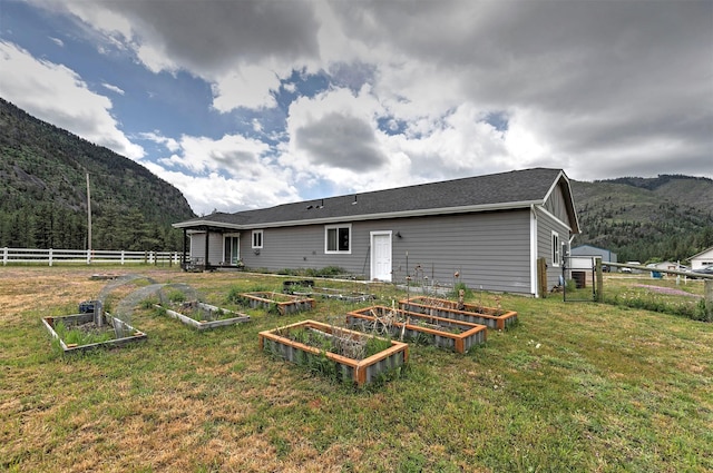 301 Bernie Rd, Alberton, MT 59820 - rear view of house featuring a vegetable garden and a mountain view