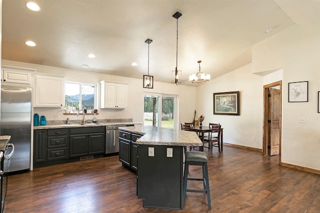 301 Bernie Rd, Alberton, MT 59820 - kitchen with stainless steel appliances, lofted ceiling, a center island, white cabinets, and a sink