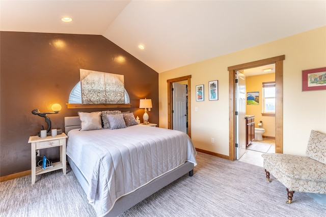 bedroom featuring vaulted ceiling, light carpet, baseboards, ensuite bath, and recessed lighting