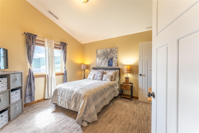 bedroom featuring vaulted ceiling and baseboards