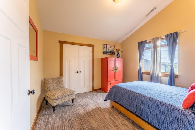 bedroom featuring lofted ceiling, carpet flooring, a closet, and baseboards