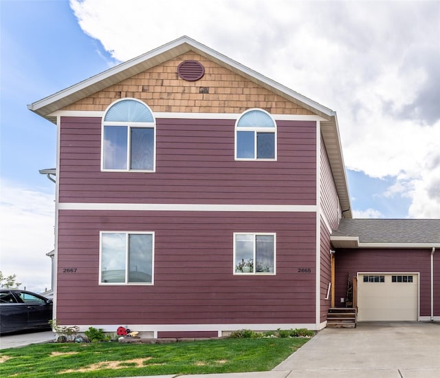 view of front of property featuring an attached garage and driveway