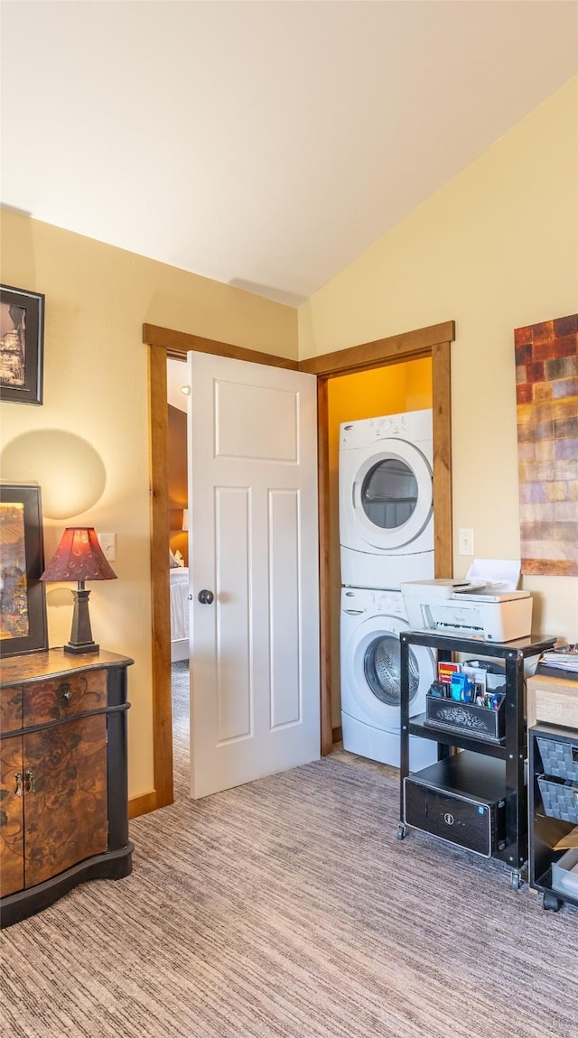washroom featuring stacked washer / dryer and carpet floors