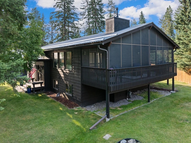 135 Sapphire Ct, Whitefish, MT 59937 - back of house featuring a sunroom and a chimney