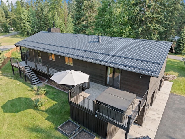 135 Sapphire Ct, Whitefish, MT 59937 - back of property featuring a lawn, metal roof, and a wooden deck