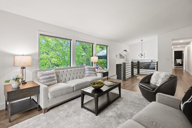 135 Sapphire Ct, Whitefish, MT 59937 - living area featuring a chandelier, wood finished floors, and baseboards