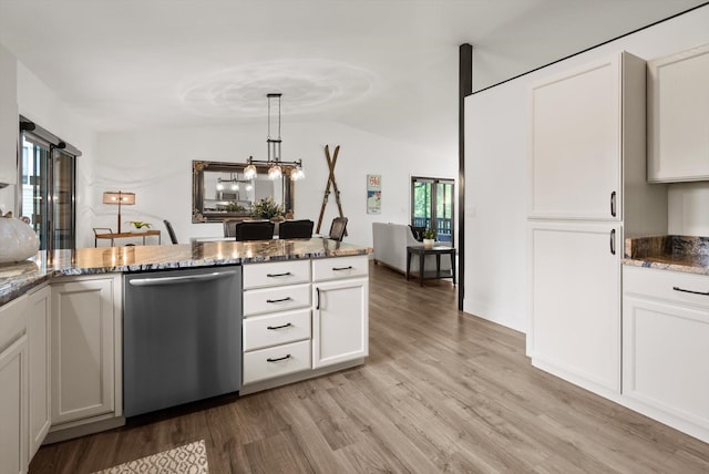 135 Sapphire Ct, Whitefish, MT 59937 - kitchen with dishwasher, light wood finished floors, dark stone counters, vaulted ceiling, and white cabinetry