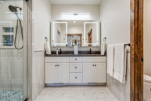 full bathroom with a shower stall, double vanity, toilet, and tile patterned flooring