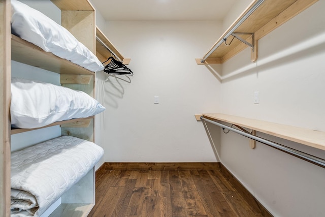 spacious closet with dark wood-type flooring